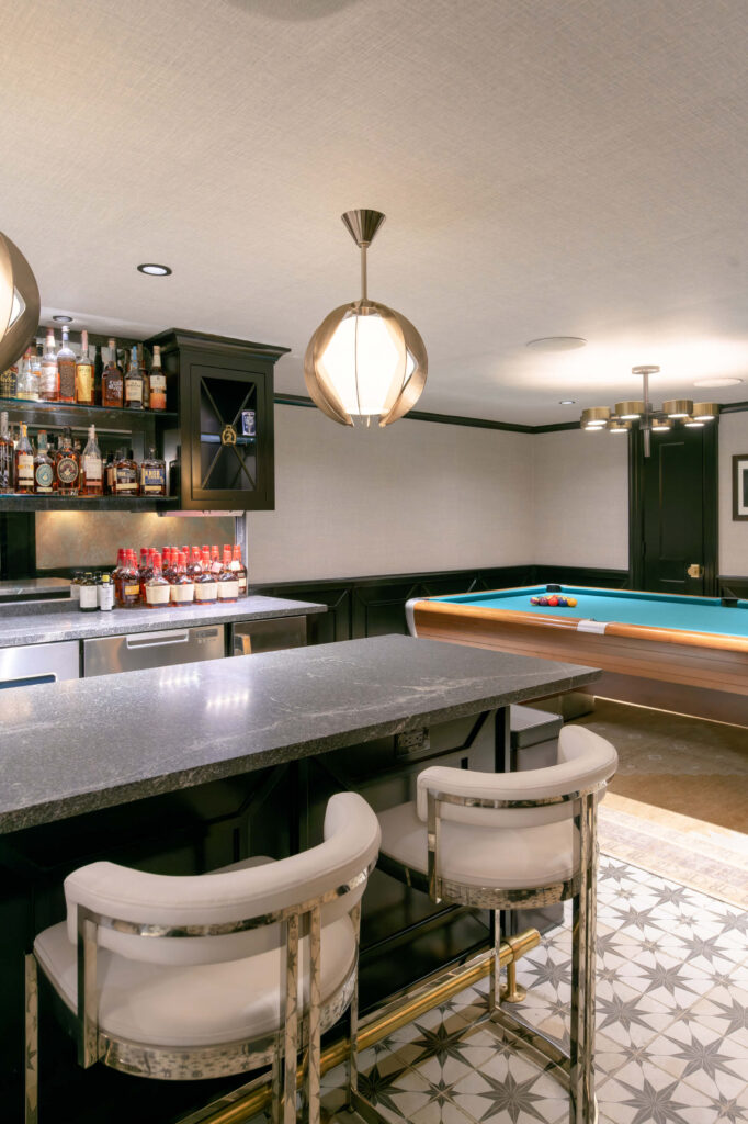 Basement room with a tastefully lit bar and pool table