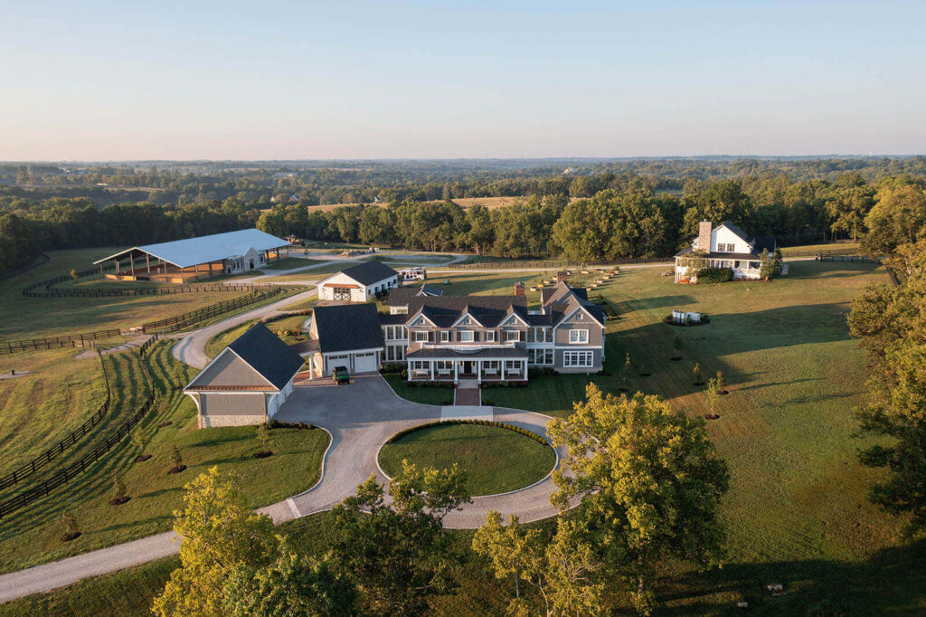 a sprawling equine estate complete with manor, riding arena, pool, greenhouse, and attached garage